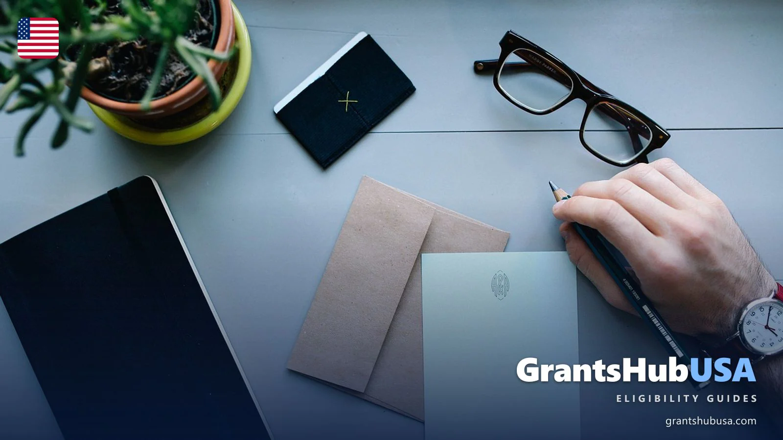 Hand writing letter at home desk with envelope, glasses, and notebook representing LIHEAP application correspondence and status tracking