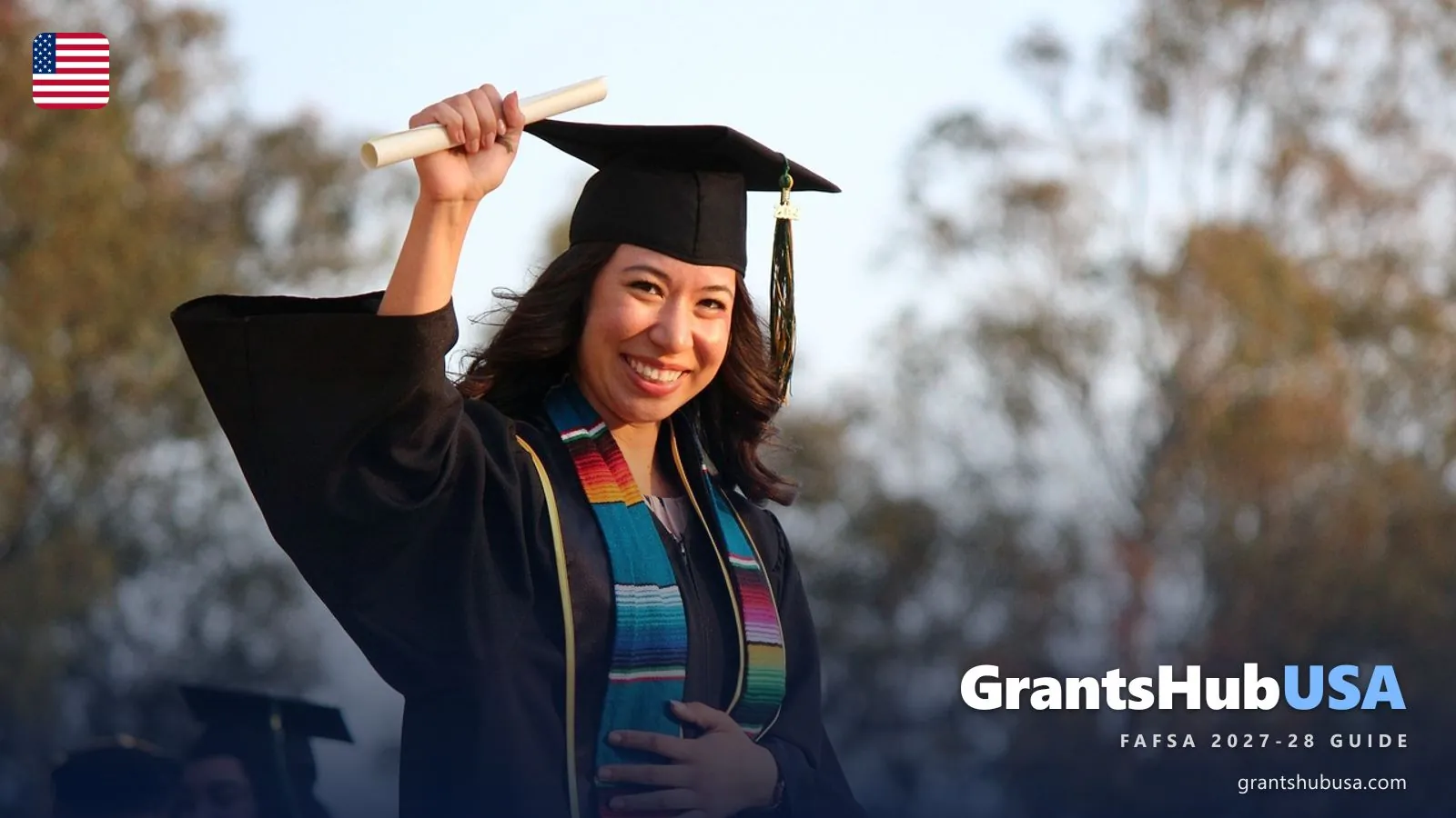 Smiling college graduate in cap and gown holding her diploma at an outdoor commencement ceremony, illustrating the college goal that the 2027-28 FAFSA form helps American students fund. GrantsHubUSA FAFSA 2027-28 guide.