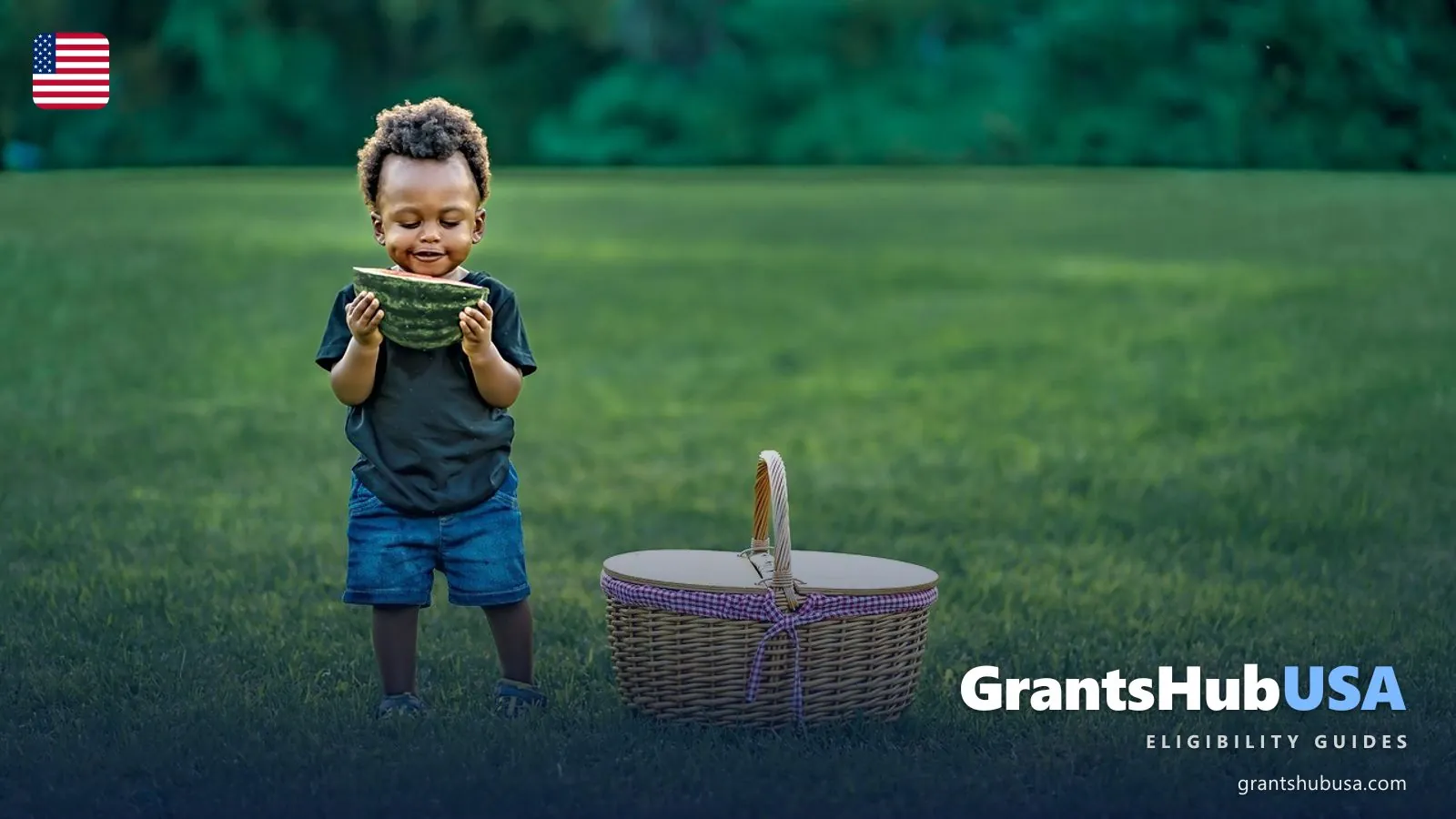 A young child in a summer park eating a slice of watermelon next to a wicker picnic basket, illustrating the 2026 Summer EBT program that provides $120 per eligible child in grocery benefits when school is out. GrantsHubUSA Summer EBT eligibility guide.