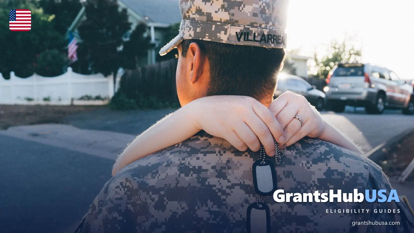 A service member in uniform with a loved one's arms around his shoulders holding his dog tags, illustrating CHAMPVA health coverage for veterans' families. GrantsHubUSA veterans guide.